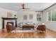Cozy living room showcasing a fireplace, hardwood floors, and comfortable seating at 10546 Sundial Rim Rd, Highlands Ranch, CO 80126