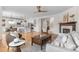 Bright, open-concept living space featuring hardwood floors, a fireplace, and a view of the kitchen at 10546 Sundial Rim Rd, Highlands Ranch, CO 80126