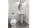 Chic powder room featuring a pedestal sink, updated fixtures, and patterned flooring at 10546 Sundial Rim Rd, Highlands Ranch, CO 80126