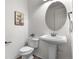 Stylish powder room with pedestal sink, modern fixtures, and patterned tile flooring at 10546 Sundial Rim Rd, Highlands Ranch, CO 80126