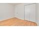Bedroom featuring hardwood floors, a closet, and neutral color scheme at 4972 W Custer Pl, Denver, CO 80219