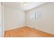 Serene bedroom with hardwood floors and a large window for natural light at 4972 W Custer Pl, Denver, CO 80219