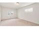 Bedroom featuring neutral carpet, two windows with natural light, and ceiling light at 4972 W Custer Pl, Denver, CO 80219