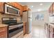 Well-equipped kitchen with stainless steel appliances, granite countertops, and ample cabinet space at 4972 W Custer Pl, Denver, CO 80219