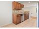 Functional kitchen featuring granite countertops, tile flooring, and updated appliances at 4972 W Custer Pl, Denver, CO 80219