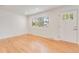 Cozy living space with hardwood floors, large window, and a freshly painted white walls at 4972 W Custer Pl, Denver, CO 80219
