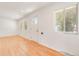 Bright Living Room with hardwood floors, white door, and natural lighting at 4972 W Custer Pl, Denver, CO 80219