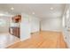 Bright living room boasts hardwood floors and a seamless transition to the modern kitchen at 4972 W Custer Pl, Denver, CO 80219