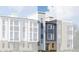 New construction townhome with modern design, gray siding, stone accents, and large windows at 14269 Currant St, Broomfield, CO 80020