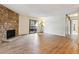 Bright living room with hardwood floors and a stone fireplace at 337 Wright St # 207, Lakewood, CO 80228