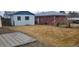 Backyard featuring a patio, two homes, and a large area of grass at 3601 W 80Th Ave, Westminster, CO 80031