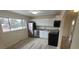 Modern kitchen featuring stainless steel appliances, sleek white cabinetry, and a spacious window for natural light at 3601 W 80Th Ave, Westminster, CO 80031