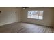 Bright and airy living room with stylish laminate flooring, a ceiling fan, and a large window at 3601 W 80Th Ave, Westminster, CO 80031