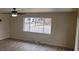 Living room featuring an ceiling fan, a large window, and neutral walls at 3601 W 80Th Ave, Westminster, CO 80031