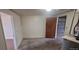 Basement area with a door to the garage, white walls, and water heater at 3601 W 80Th Ave, Westminster, CO 80031