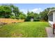 Well-maintained backyard featuring a large lawn, wooden fence, and storage shed at 6402 Iris Ct, Arvada, CO 80004
