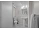 Cozy bathroom featuring a toilet, shower, and pedestal sink with modern lighting at 6402 Iris Ct, Arvada, CO 80004