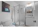 Clean, minimalist bathroom with tiled floors, glass-enclosed shower, and modern fixtures at 6402 Iris Ct, Arvada, CO 80004