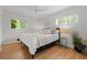 Inviting bedroom features hardwood floors, abundant natural light, and serene decor at 6402 Iris Ct, Arvada, CO 80004