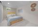 Basement bedroom with neutral walls features a platform bed, carpet, and small window at 6402 Iris Ct, Arvada, CO 80004