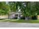 Quaint single-story home with lush green lawn and mature shade trees. A peaceful suburban setting at 6402 Iris Ct, Arvada, CO 80004