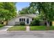 Charming single-story home featuring a well-manicured lawn, mature trees, and inviting curb appeal at 6402 Iris Ct, Arvada, CO 80004