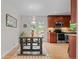 Bright dining area adjacent to a modern kitchen with stainless steel appliances and plenty of natural light at 6402 Iris Ct, Arvada, CO 80004