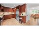 Kitchen featuring wooden cabinets, stainless steel refrigerator, and a view into the living room at 6402 Iris Ct, Arvada, CO 80004