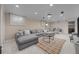 Expansive living room with gray sectional and rug offers a cozy and inviting atmosphere at 6402 Iris Ct, Arvada, CO 80004