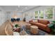 Bright, airy living room features modern decor and natural light, creating a welcoming and stylish space at 6402 Iris Ct, Arvada, CO 80004