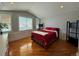 Bright bedroom with red bedding and hardwood floors at 2670 S Hooker St, Denver, CO 80219