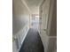 Long hallway with carpeted floor and neutral walls at 2670 S Hooker St, Denver, CO 80219