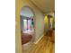 Shows a view down the hallway with arched doorways and hardwood flooring at 2670 S Hooker St, Denver, CO 80219