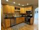 Kitchen with wood cabinets, granite countertops, and stainless steel appliances at 2670 S Hooker St, Denver, CO 80219