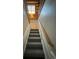 Wooden staircase with carpeted steps and wooden railing at 2670 S Hooker St, Denver, CO 80219