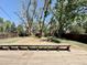 Expansive backyard featuring mature trees, a sturdy fence, and a wooden deck at 7195 E Louisiana Ave, Denver, CO 80224