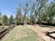 Large backyard featuring a patio, lush greenery, a sturdy fence, and mature trees at 7195 E Louisiana Ave, Denver, CO 80224