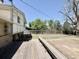 Large backyard features a patio, lush greenery, a sturdy fence, and mature trees at 7195 E Louisiana Ave, Denver, CO 80224