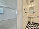 Basement bathroom with vintage pedestal sink and black and white tile floor at 7195 E Louisiana Ave, Denver, CO 80224