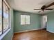 Bedroom with two windows, a ceiling fan, and hardwood floors at 7195 E Louisiana Ave, Denver, CO 80224
