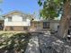 Charming home featuring a brick facade, a wooden porch, mature trees, and easy access via the concrete walkway at 7195 E Louisiana Ave, Denver, CO 80224