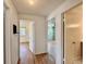 Hallway with hardwood floors providing access to multiple bedrooms at 7195 E Louisiana Ave, Denver, CO 80224