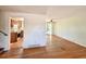Spacious living room with hardwood floors, connecting seamlessly to the kitchen and dining area at 7195 E Louisiana Ave, Denver, CO 80224