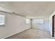 Neutral living room features three windows, carpet flooring, and is ready to be redesigned to your liking at 7195 E Louisiana Ave, Denver, CO 80224