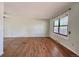 Bright living room boasts hardwood floors and natural light streaming through a large window at 7195 E Louisiana Ave, Denver, CO 80224