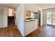 Open-concept space with hardwood floors, connecting the living room to the kitchen and outdoor patio at 7195 E Louisiana Ave, Denver, CO 80224