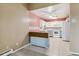 Charming kitchen with white cabinets, tiled floors, and an adjacent breakfast bar at 3022 S Wheeling Way # 407, Aurora, CO 80014