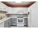 Charming kitchen with white cabinets, modern appliances, and plenty of counter space at 3022 S Wheeling Way # 407, Aurora, CO 80014