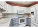 Charming kitchen with white cabinets, modern appliances, and plenty of counter space at 3022 S Wheeling Way # 407, Aurora, CO 80014