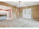 Bright living room featuring an open layout, built-in shelving, and carpet at 3022 S Wheeling Way # 407, Aurora, CO 80014